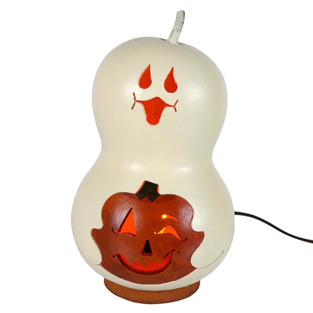 Cream-colored lighted ghost gourd carved with ghost face and jack o lantern from meadowbrooke gourds spooky boo