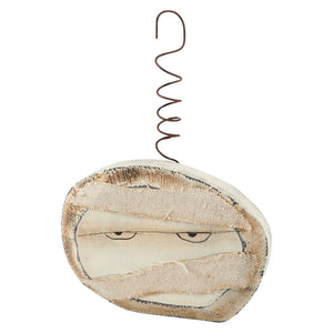 A rustic off-white mummy-themed spooky ornament with fabric bandages and a coiled wire hanger from the spooky ornament set