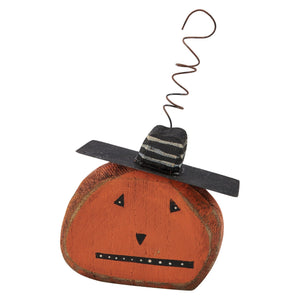 Orange wooden pumpkin decoration with a black and white striped hat and coiled wire stem spooky ornament set vintage inspired