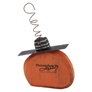 Orange wooden pumpkin ornament with black and white striped hat and coiled wire stem from spooky ornament set