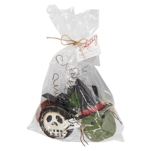 A spooky ornament set featuring black green and white halloween masks with painted facial features for decoration