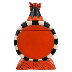 A whimsical orange and black striped laughing treat box with a bow-topped lid inspired by jack o lanterns