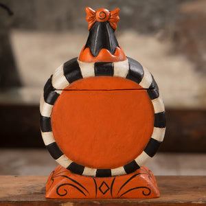 Orange and black striped ceramic laughing treat box with decorative bow inspired by jack o lantern design