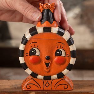 Orange ceramic halloween laughing treat box with jack o lantern face and black white striped collar and bow lid