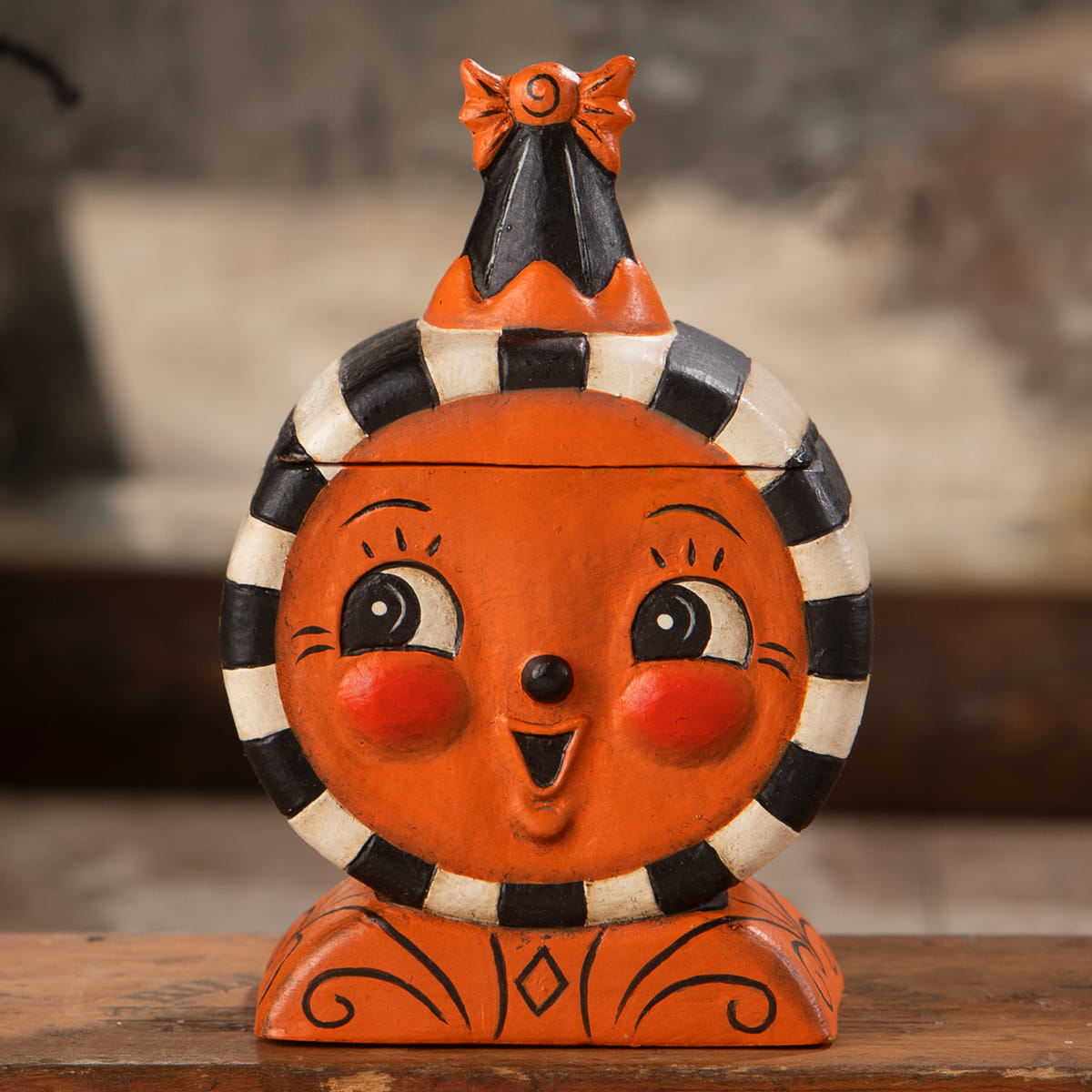 Orange ceramic jack o lantern laughing treat box with black and white striped collar rosy cheeks and bow hat