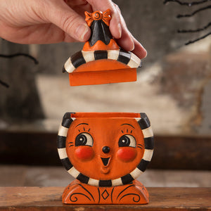 Orange ceramic halloween laughing treat box with smiling jack o lantern face and black white striped accents