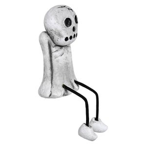 White distressed resin spooky skull shelf sitter with black eye mouth details seated on black cord legs