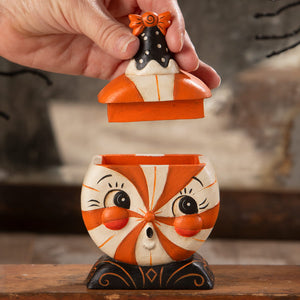 Orange and white candy-striped ceramic treat box with black polka dot lid and orange bow for spooky jack o lantern gifts