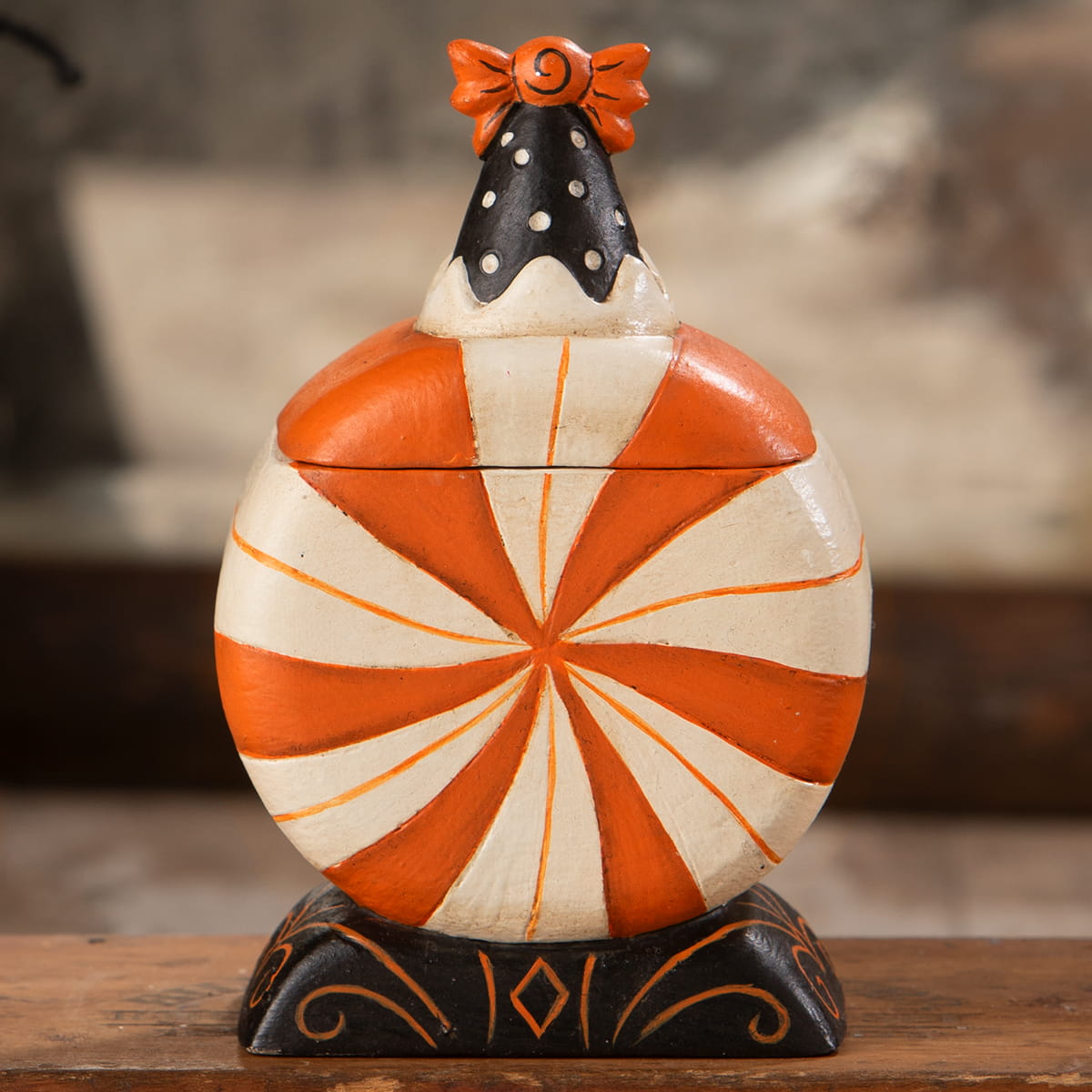 Orange and white peppermint candy ceramic jar with black polka dot lid and orange bow in spooky surprise treat box jack o lantern