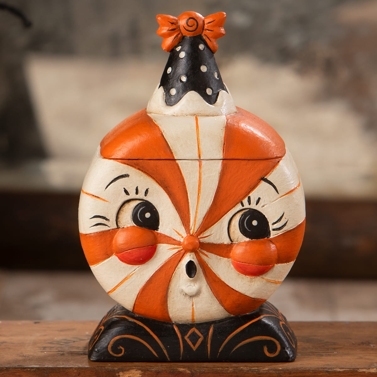 Whimsical orange and white candy-striped ceramic jack o lantern treat box with a black polka-dotted hat and orange bow