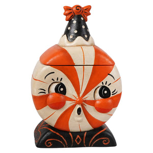 A whimsical orange and white candy cane treat box with a black polka-dotted hat and orange bow for spooky surprise
