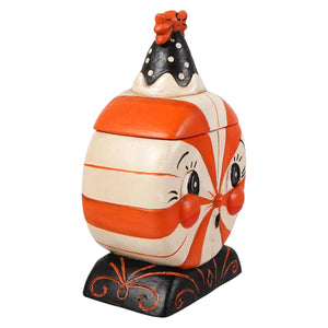 A whimsical candy cane striped treat box with painted eyes, rosy cheeks, and a black hat for spooky surprise fun