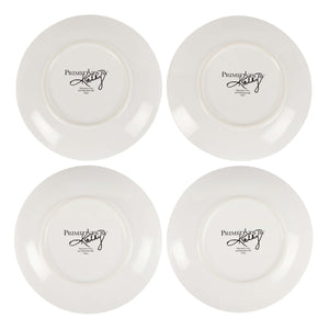 White ceramic spring plate set with glossy finish showing primitives by kathy logo on the back of each saucer