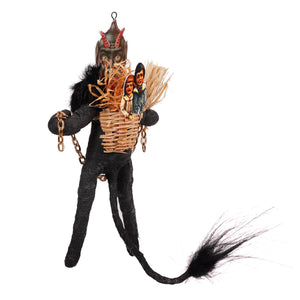 Black krampus freestand ornament with spun cotton black devil figurine red horns green eyes holding woven basket