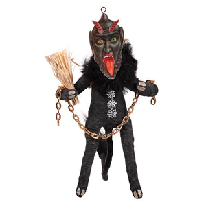 Black krampus freestand ornament made of spun cotton featuring a black devil with red horns and silver snowflake attire