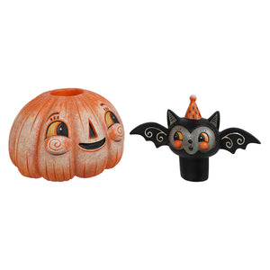 Orange pumpkin-shaped candle holder with painted face and black bat figurine wearing orange party hat for halloween pumpkins and gourds decor