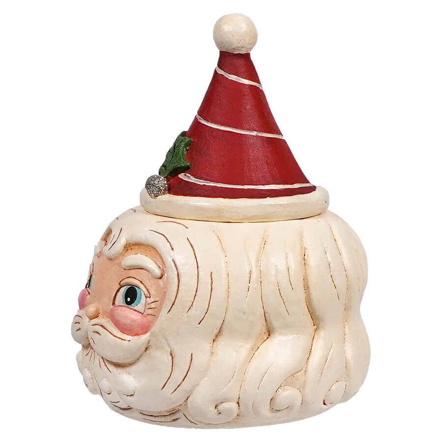 Ceramic Santa Claus head container with a red conical lid decorated with white stripes.