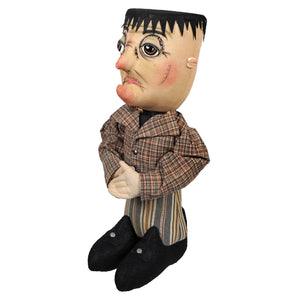 A handcrafted carlos stein doll with painted face, black spiky hair, plaid jacket, and striped pants from joe spencer halloween dolls & decor