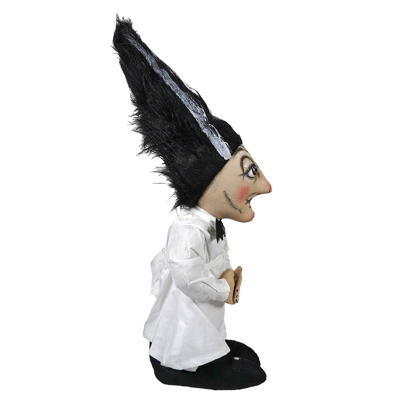A whimsical standing carmella stein doll wearing a tall black feathered hat with white lace trim and white blouse