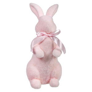 Pink plush bunny with a bow around its neck.