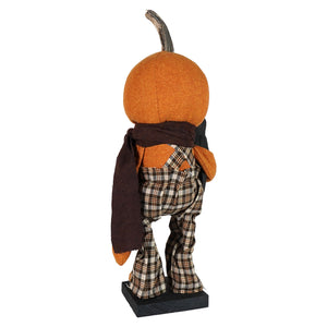 Standing scarecrow figurine in orange pumpkin shape wearing plaid overalls and dark scarf by raggedy junction design handcrafted folk art tall harvest helper