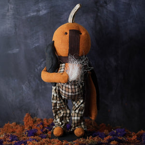 Orange pumpkin-shaped plush standing scarecrow with black cape and plaid pants handcrafted folk art design
