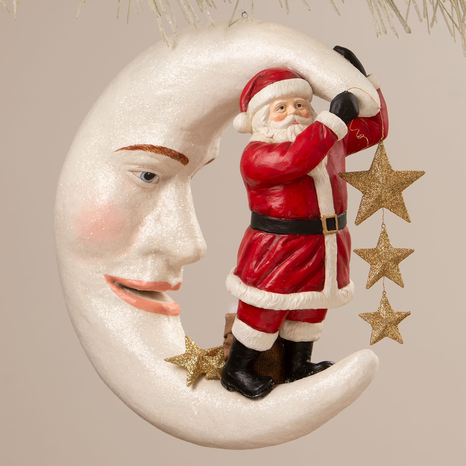 A festive bethany lowe designs santa figure in red and white on a smiling moon with glittery gold stars dangling nearby