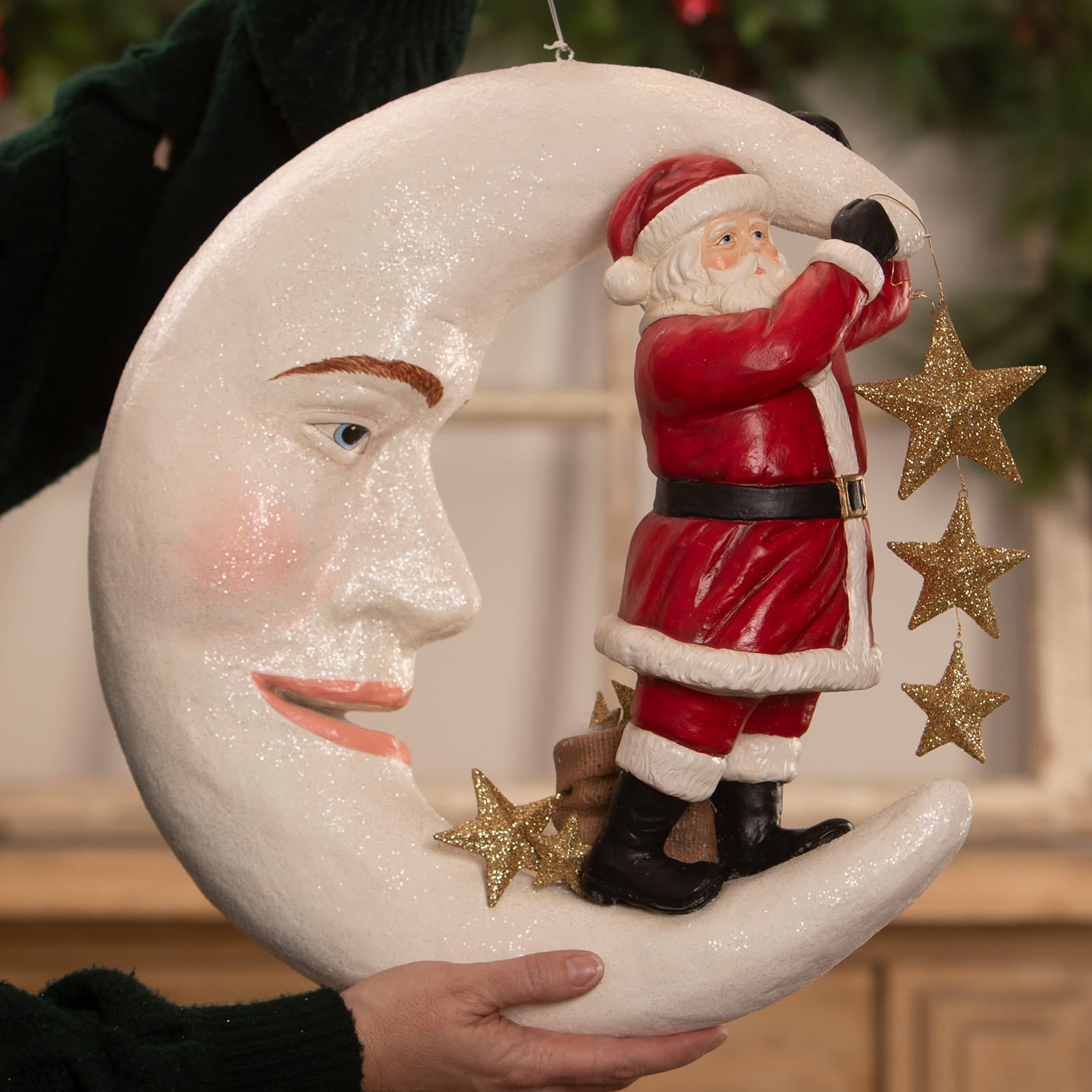 A festive white glittery crescent moon ornament with santa claus figure and gold star decorations by bethany lowe designs