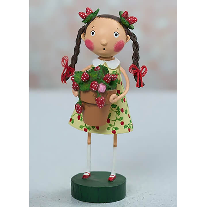 A lori mitchell strawberry fields figurine of a girl in green dress with strawberries holding a pot of fresh berries