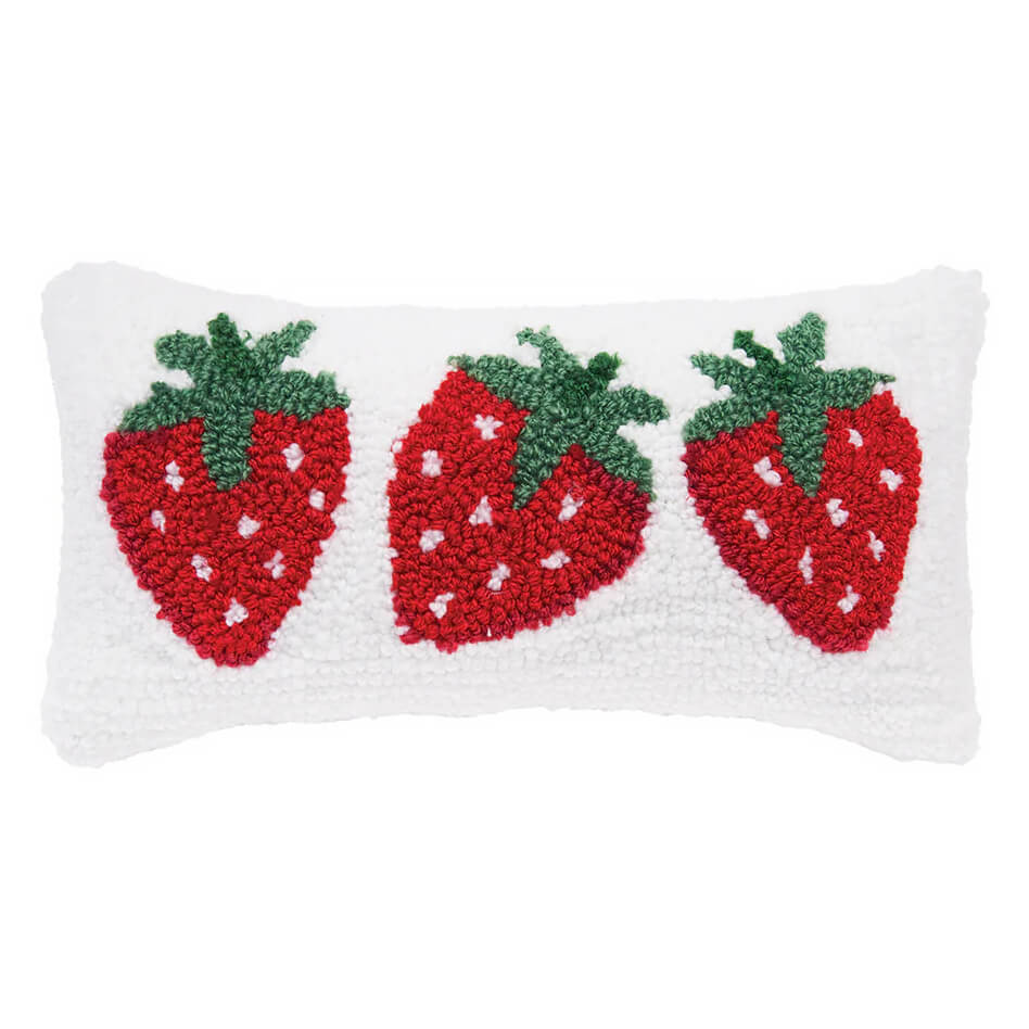 Decorative white throw pillow with three red hooked strawberries.