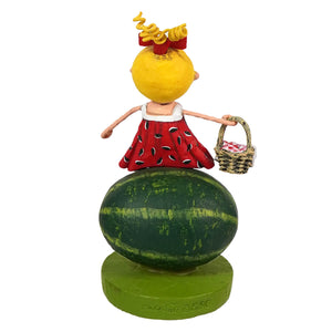 Yellow-headed lori mitchell sugar baby figurine with curly blonde hair in red watermelon dress on green base
