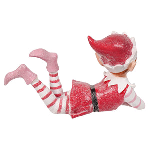 A glittery red and white sugar coated sweet lying resin elf figurine with striped leggings and pink boots