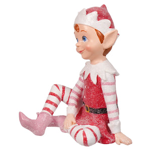 A glittery red and white sugar coated sweet resin elf figurine with candy cane leggings sitting in a festive pose