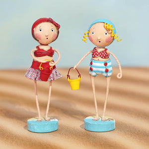 Two lori mitchell summer beach figurines in red polka-dot swimsuit and blue striped shorts on blue bases