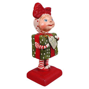 A charming bethany lowe designs surprise package girl figurine in red and white polka dots holding a green gift spreading holiday cheer