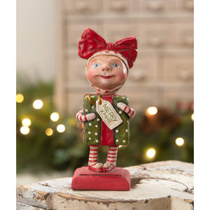 A cheerful bethany lowe designs surprise package girl figurine in red and green polka-dot clothes spreading holiday cheer