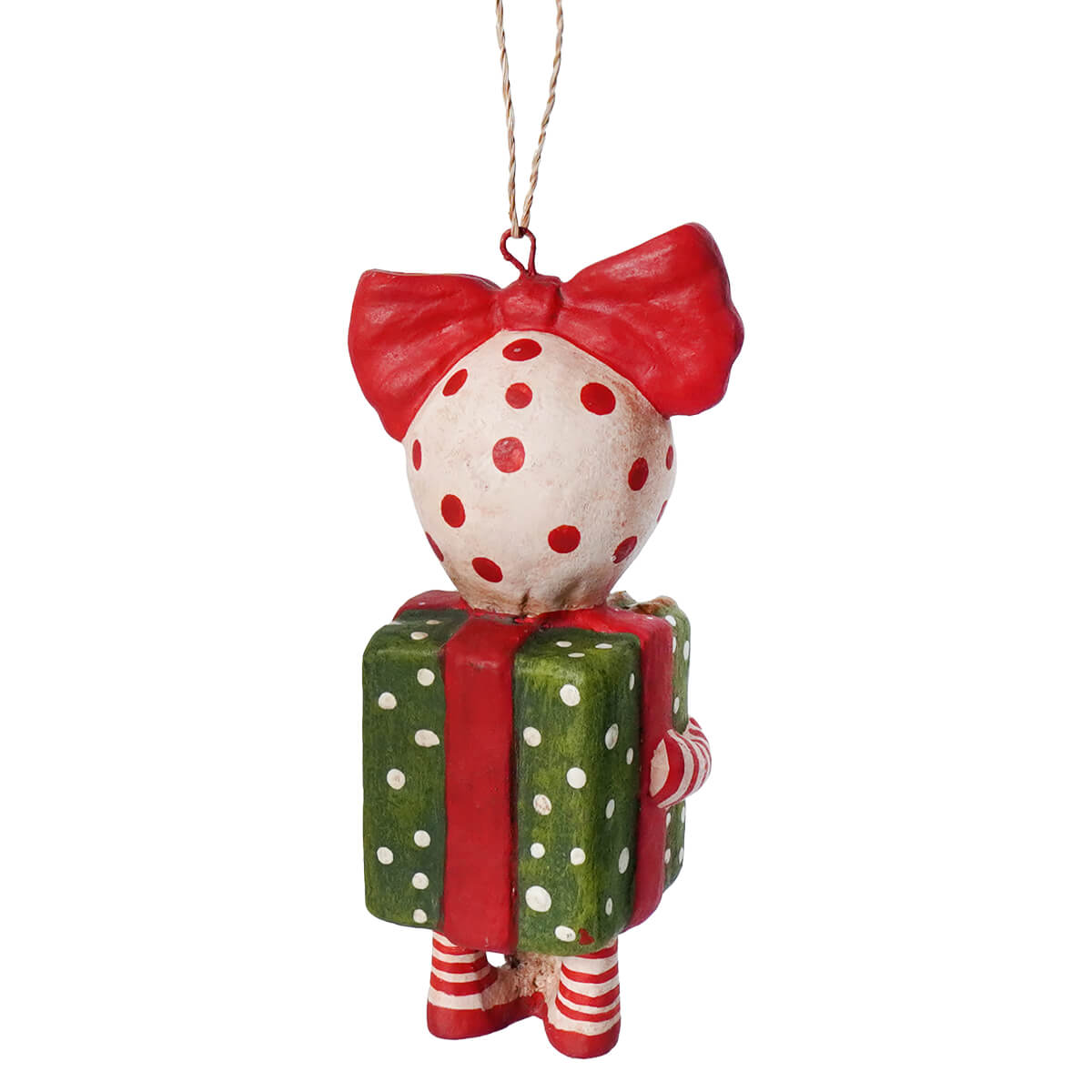 A whimsical bethany lowe designs surprise package girl ornament holding a green polka dot gift box with a red bow