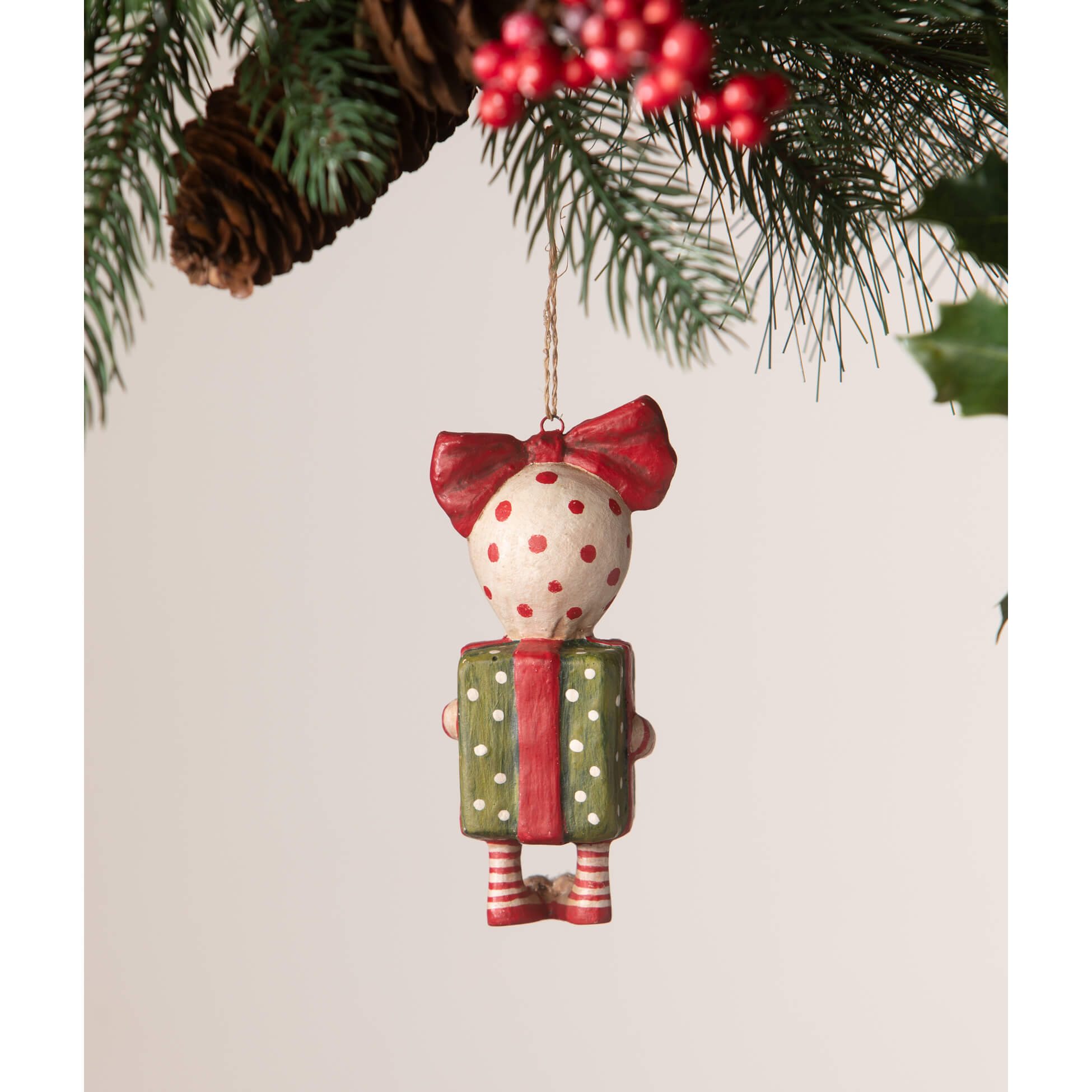 A charming bethany lowe designs surprise package girl ornament by debra schoch holding a green polka dot gift box