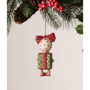 A charming bethany lowe designs surprise package girl ornament by debra schoch holding a green polka dot gift box