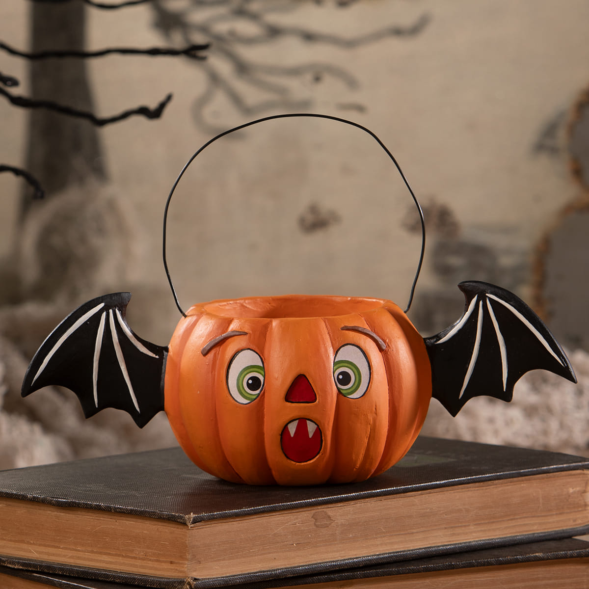 Orange pumpkin shaped halloween jack bucket with black bat wings and wire handle for halloween buckets and lanterns