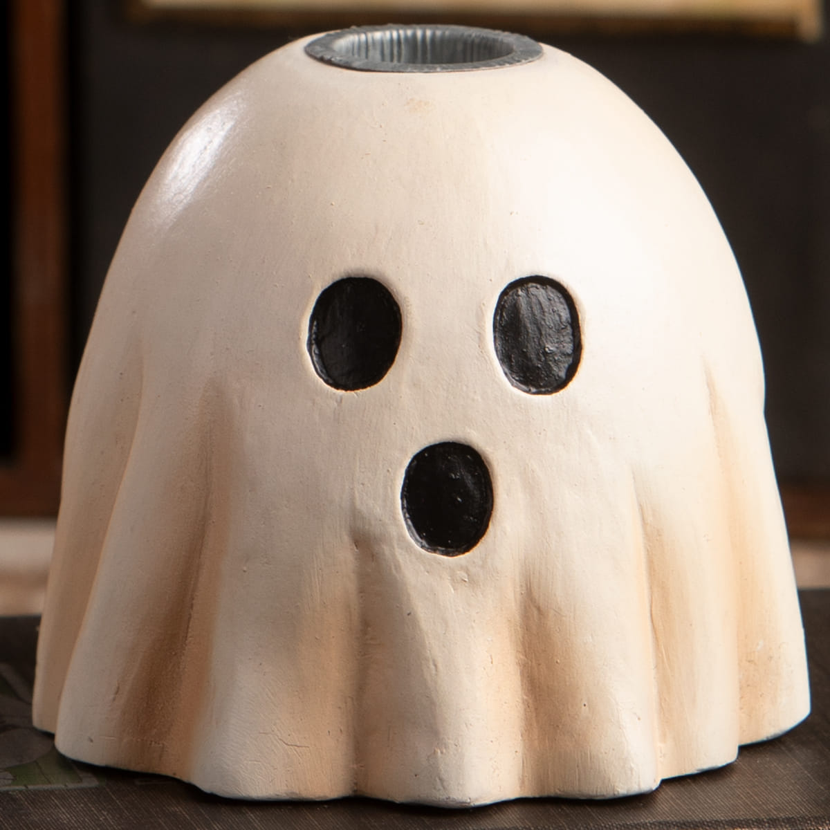 Cream-colored ceramic surprised ghost candlestick with black eye and mouth cutouts halloween ghost figures decor