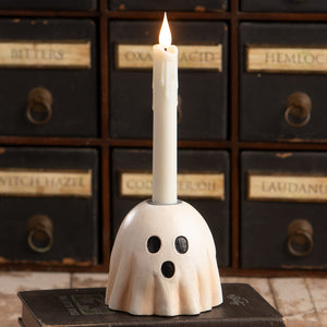 Surprised ghost candlestick with lit white taper candle featuring spooky black eyes and mouth halloween ghost figures decor
