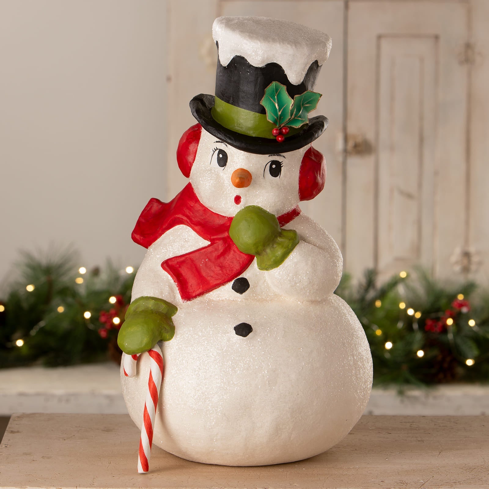 A bethany lowe design surprised snowman figurine in white with a black hat red scarf and candy cane christmas snowman decor