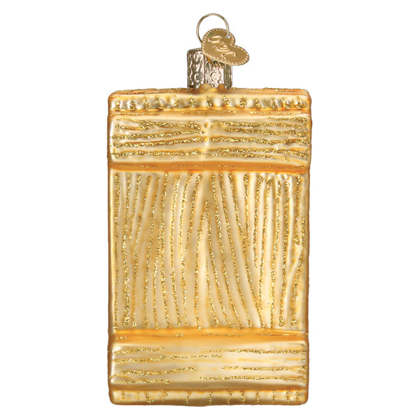 Golden glass sushi roll ornament shaped like vintage suitcase with textured stripes and metallic heart tag for figural decor