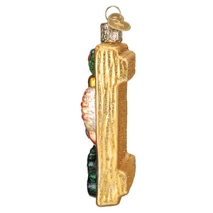 Golden glass sushi roll ornament shaped like a cactus with textured ridges and colorful glittery figural decor for world christmas