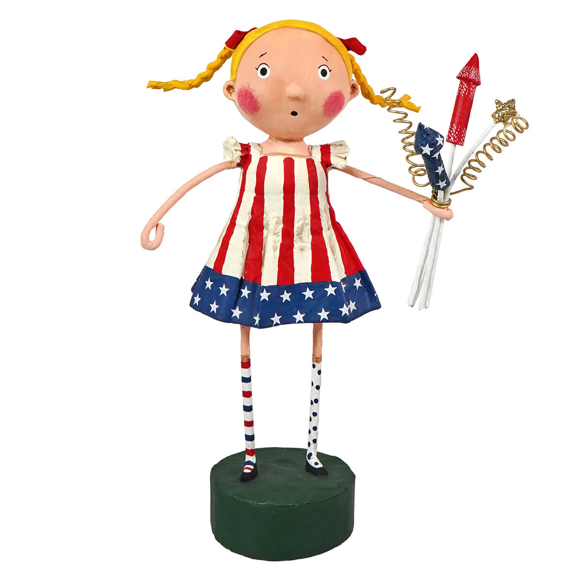 Susie sparkle figurine by lori mitchell with blonde pigtails holding fireworks in a patriotic flags dress on green base