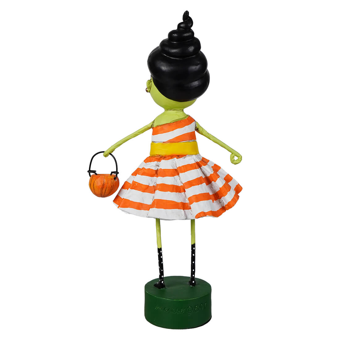 A lori mitchell halloween susie stein figurine of a green girl with black spiral hair in an orange striped dress holding a pumpkin basket