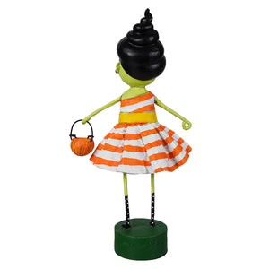 A lori mitchell halloween susie stein figurine of a green girl with black spiral hair in an orange striped dress holding a pumpkin basket