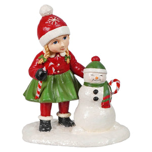 A festive resin susie figurine in red and green winter outfit standing with a smiling christmas snowman figure by bethany lowe designs