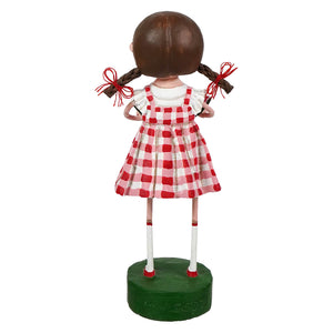 Sweet carolina lori mitchell figural decor of a girl with brown pigtails in a red white checkered dress on a green base